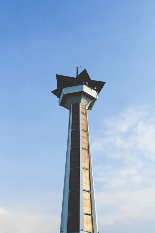 Free A star-shaped tower stands tall against a clear blue sky, showcasing modern architecture. Stock Photo