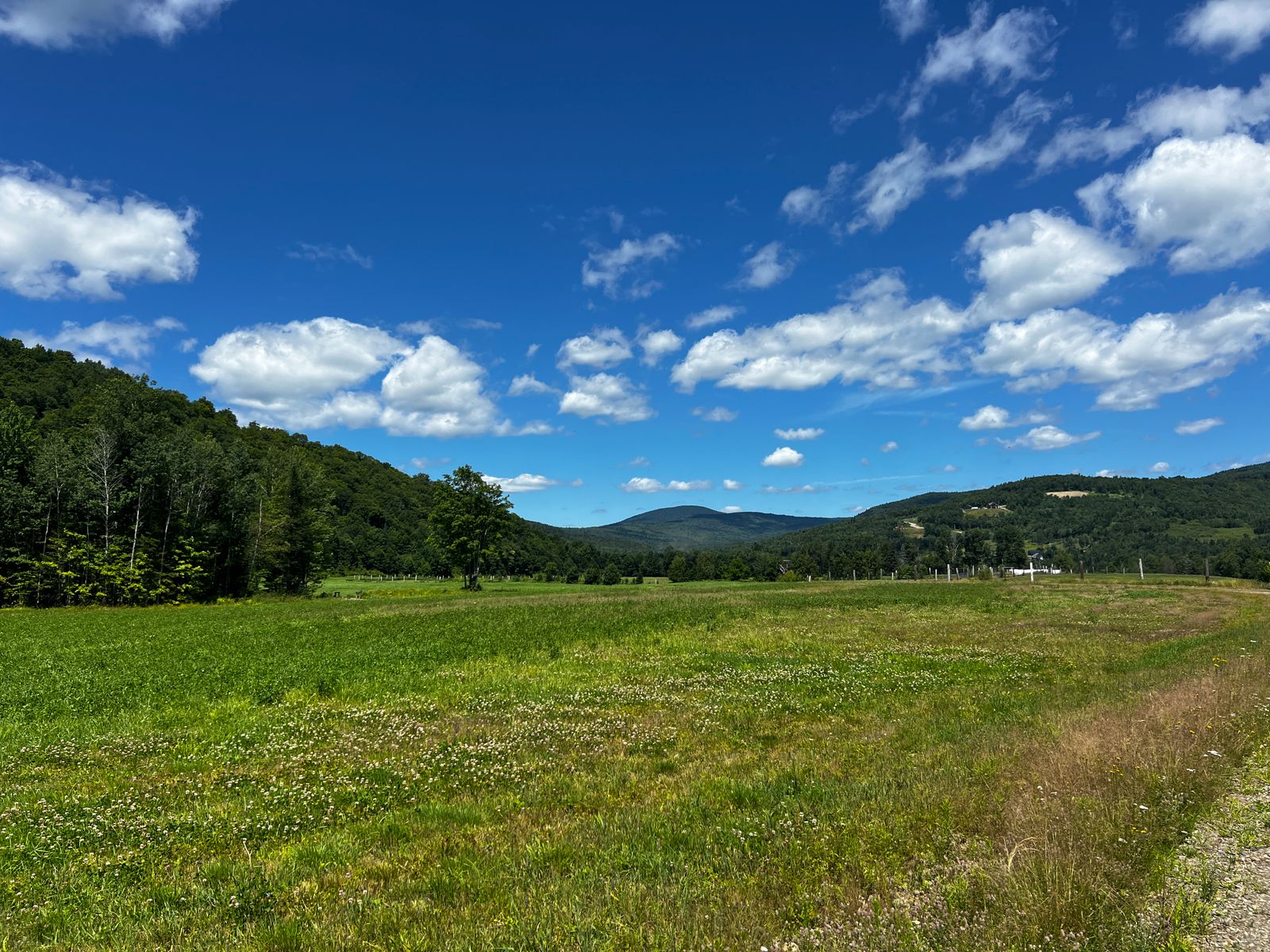 Picturesque summer landscape in New Hampshire featuring rolling hills and blue skies — Bow NH rural luxury