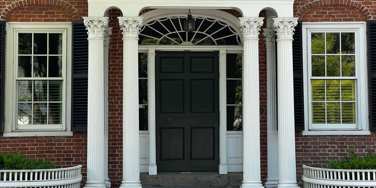 The columned entrance of a historic Greek Revival house