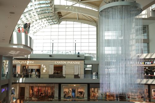 Free Shopping mall interior in Singapore featuring modern architecture and upscale retail stores. Stock Photo