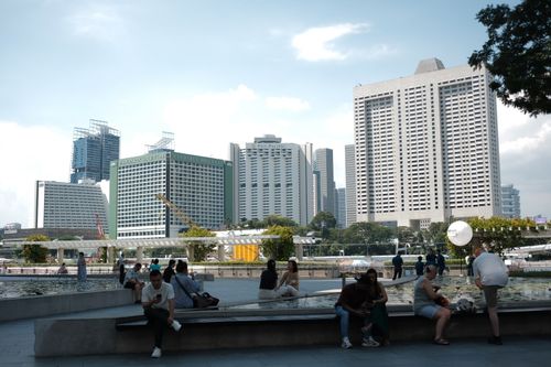 Free Discover the vibrant cityscape of Singapore with people enjoying the sunny day outdoors. Stock Photo