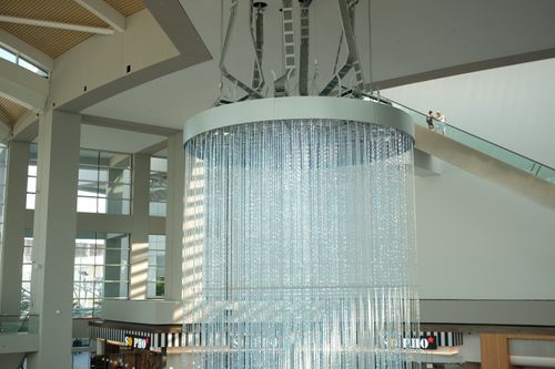 Free Sunlit modern interior with a large artistic chandelier, showcasing contemporary architecture in Singapore. Stock Photo