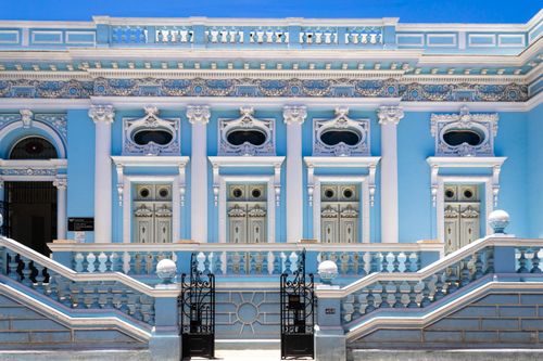 Free Elegant blue and white neoclassical architecture with ornate detailing during a sunny day. Stock Photo