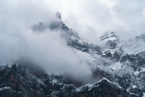 Free Dramatic view of snow-capped mountains hidden by thick clouds, showcasing nature's majestic beauty. Stock Photo