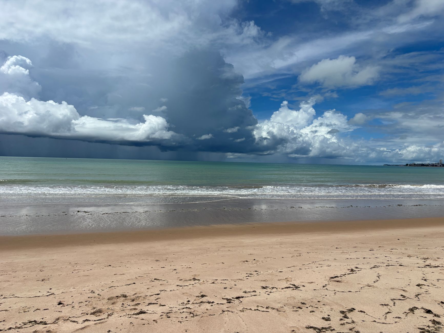 Stormy clouds gather over Tambaú Beach in Brazil, capturing a stunning coastal scene.