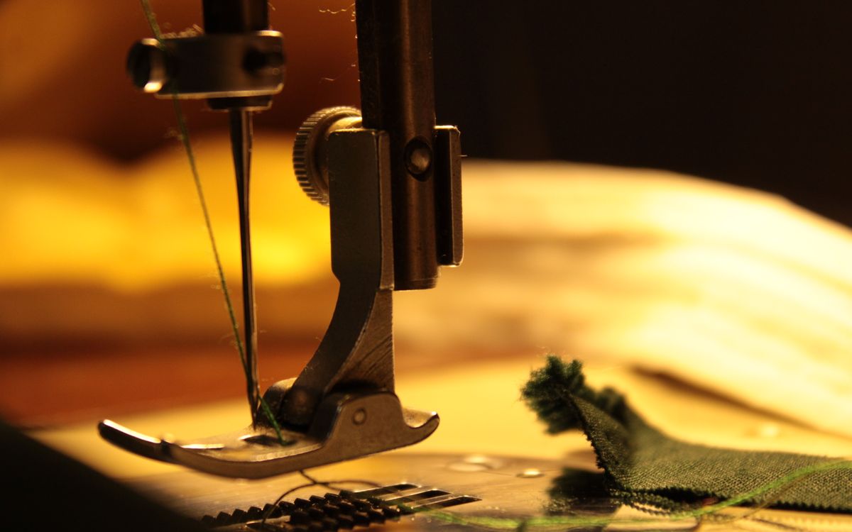 Sewing machine needle stitching fabric