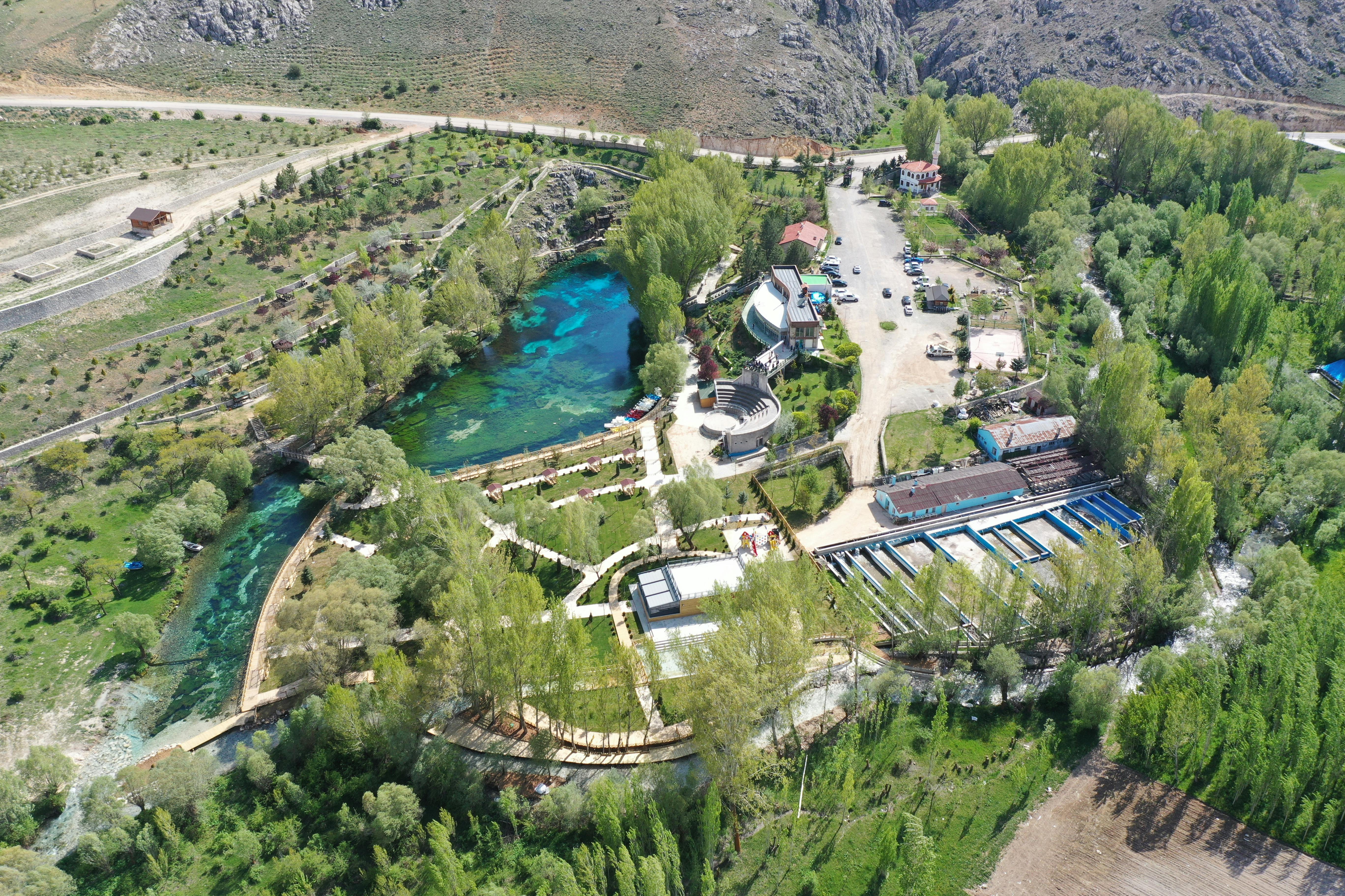 A stunning aerial shot of a green landscape with a clear water park in Sivas, Turkey.