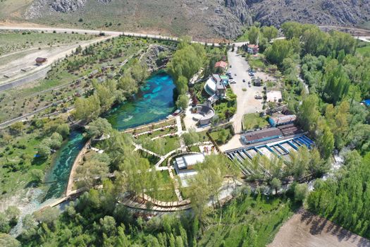 A stunning aerial shot of a green landscape with a clear water park in Sivas, Turkey.