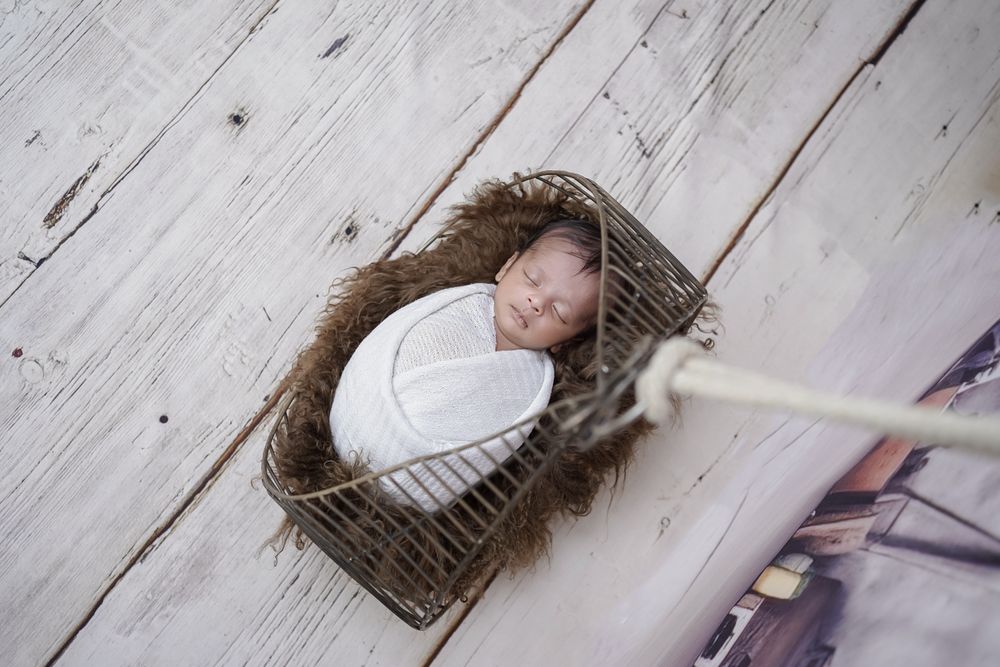 Newborn baby sleeping in a basket