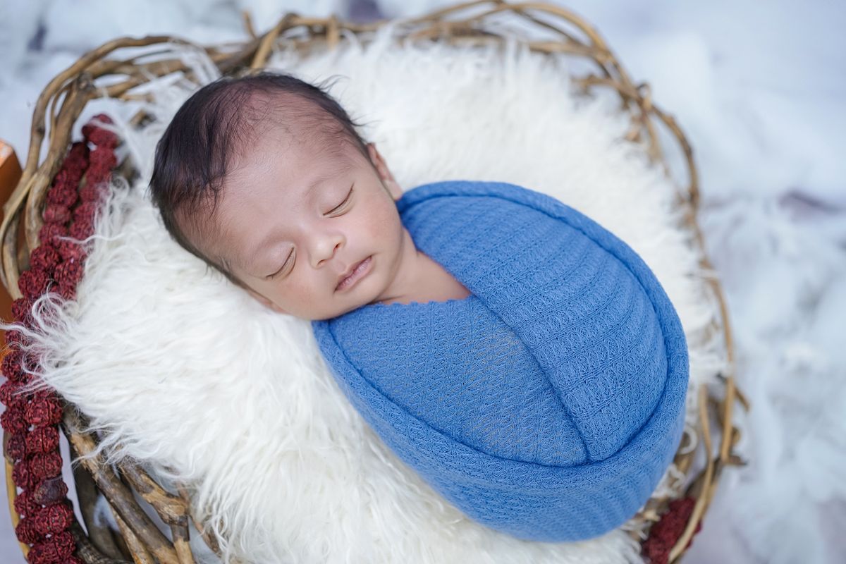Baby snug in a warm quilted winter sleep sack in a cool nursery