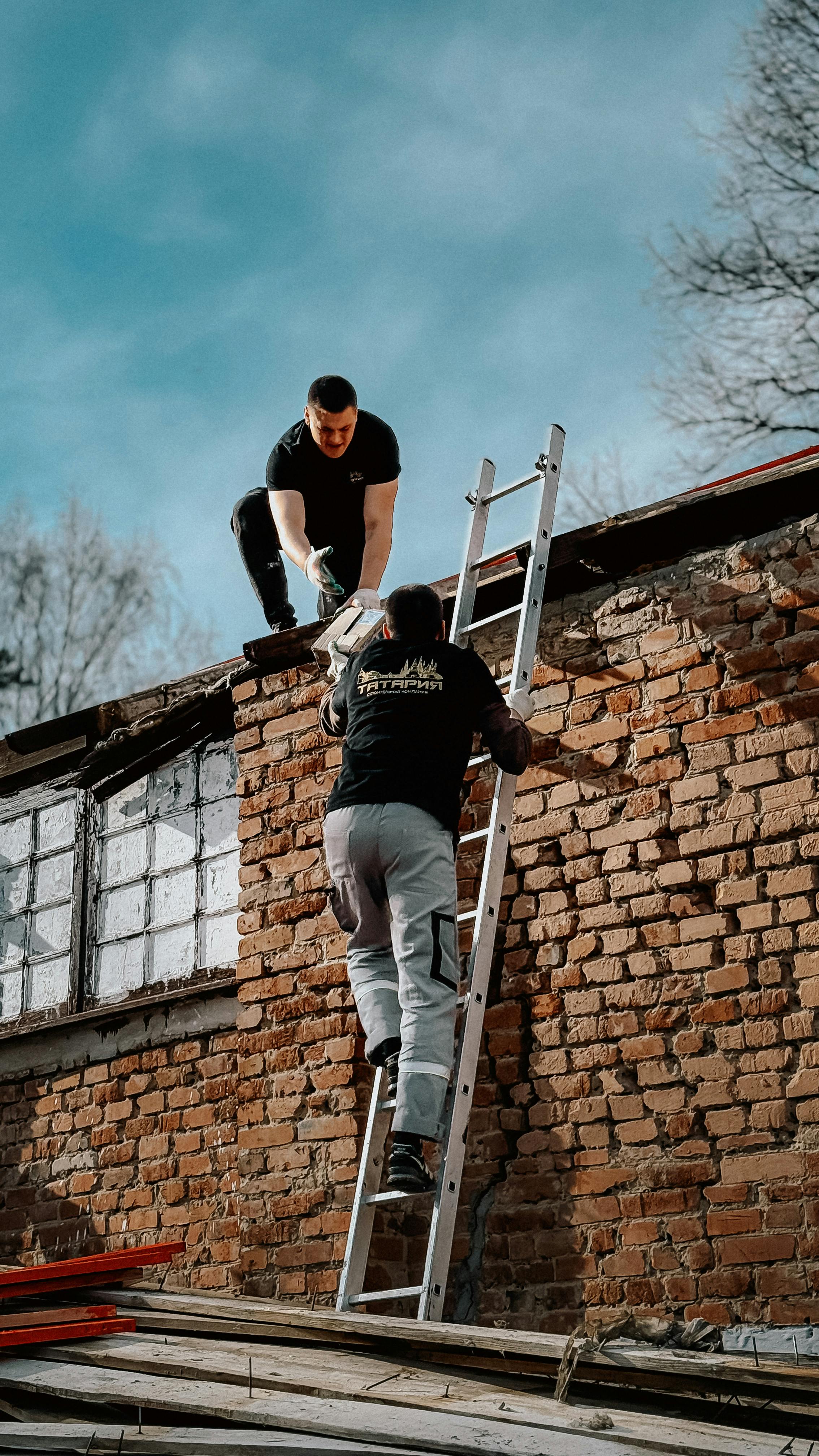 Construction workers on roof performing emergency repairs