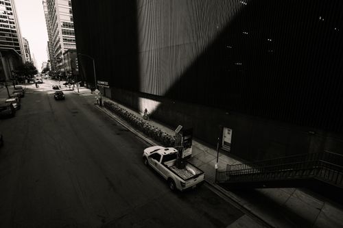 Free Black and white urban street scene in downtown Chicago with dramatic shadows and empty streets. Stock Photo