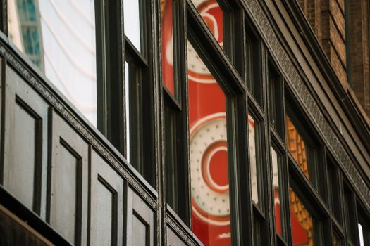 Reflections of the iconic Chicago Theater sign in downtown windows.