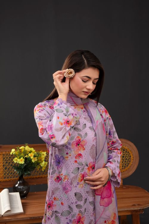 Free Elegant woman in floral dress holds a rose, indoors, portrait style. Stock Photo