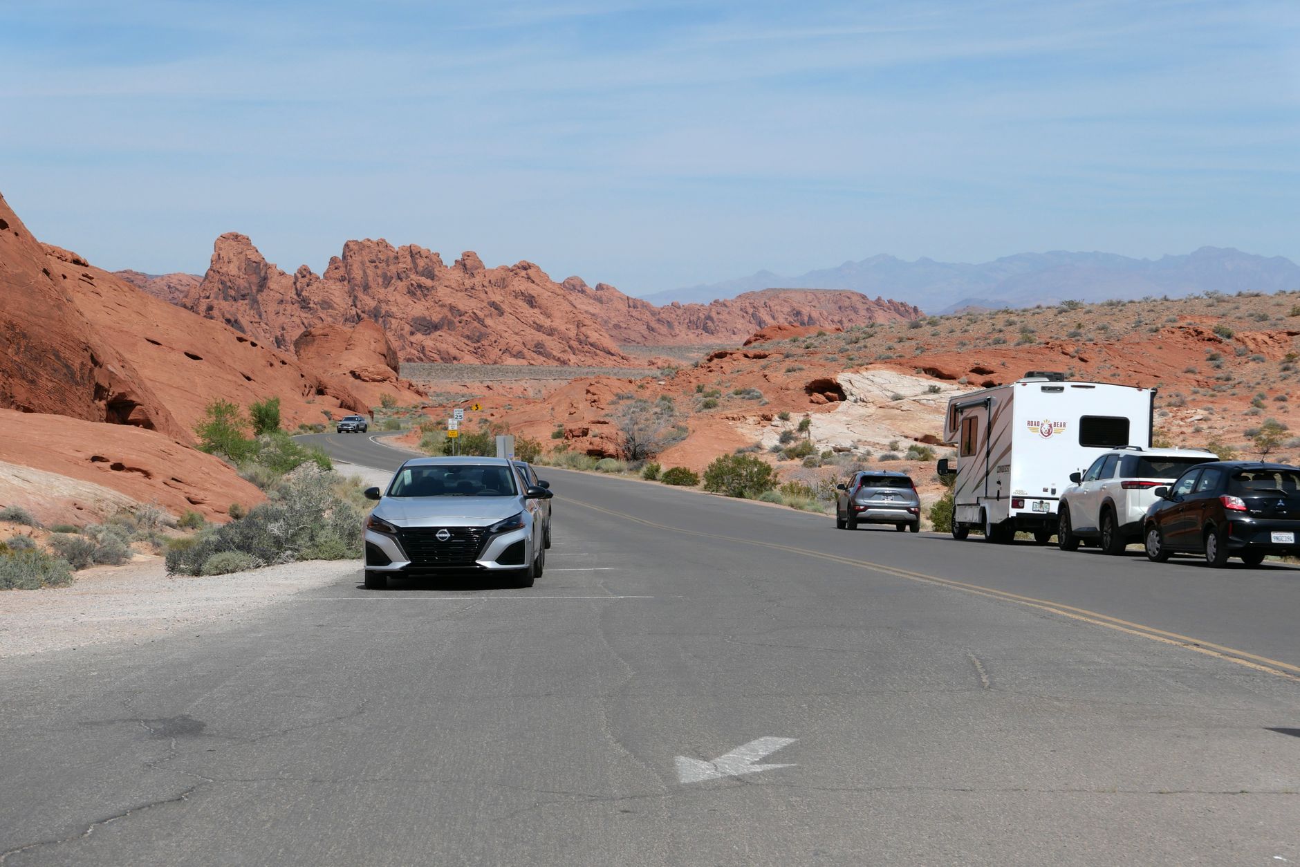 Highway 50 empty two-lane road cutting across Nevada high desert