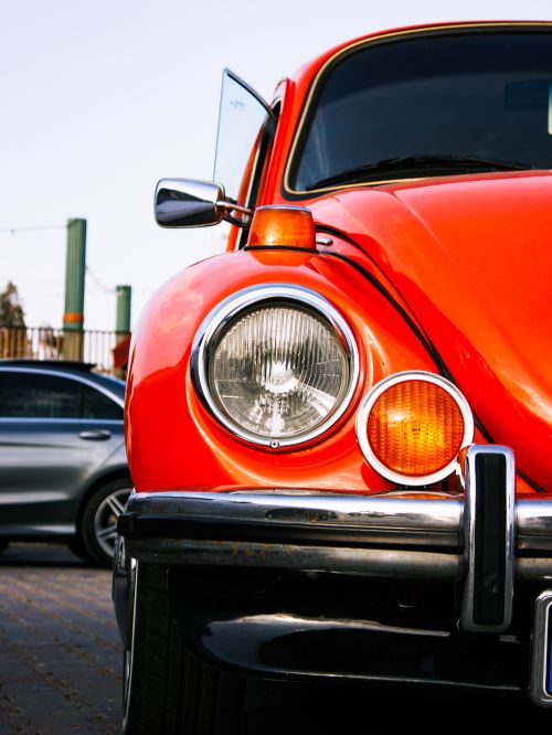 Free Detailed view of a classic red Beetle car headlight, showcasing vintage automotive design. Stock Photo
