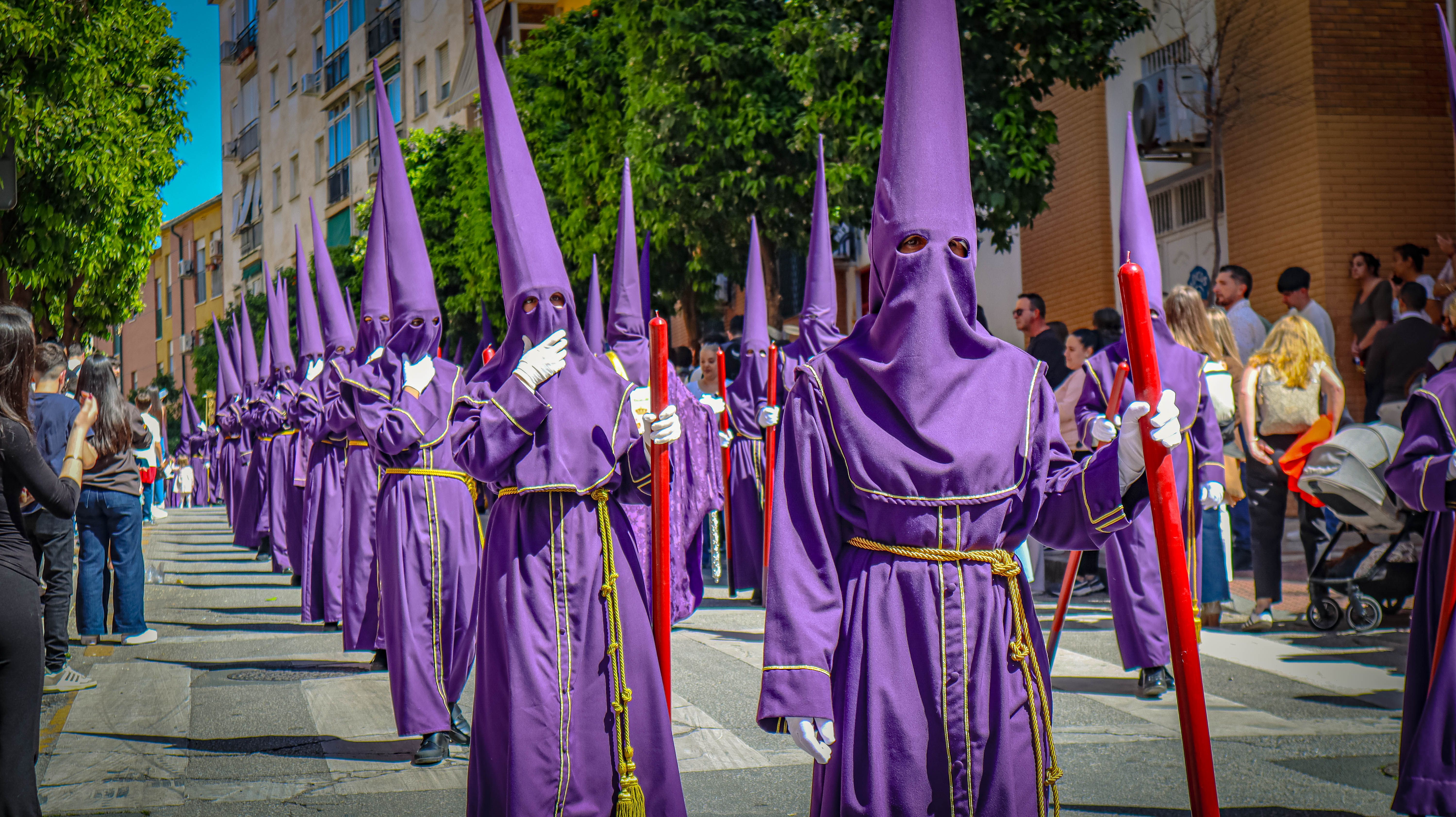 Nazarenos in purple robes participate in a Semana Santa procession in Málaga, Spain.