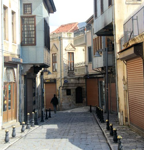 Free A peaceful narrow street in a historic district with closed shops and classic architecture. Stock Photo