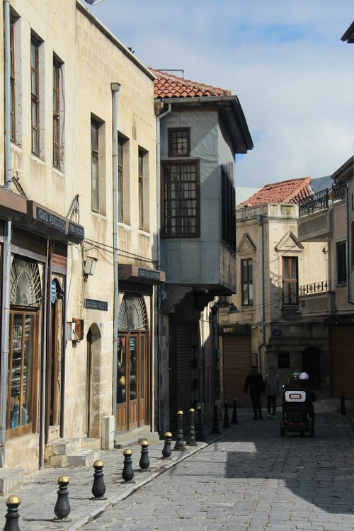 Free A quiet cobblestone street with historic architecture under a clear sky. Stock Photo