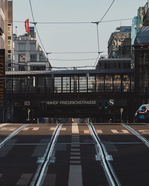 Free Empty street leading to Berlin's Bahnhof Friedrichstrasse on a clear day. Stock Photo