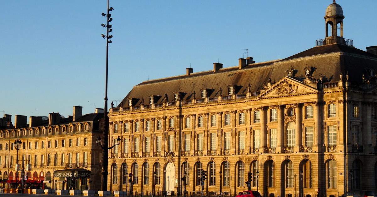 Elegant historic building in Bordeaux, France captured during golden sunset light, highlighting classic French architecture.