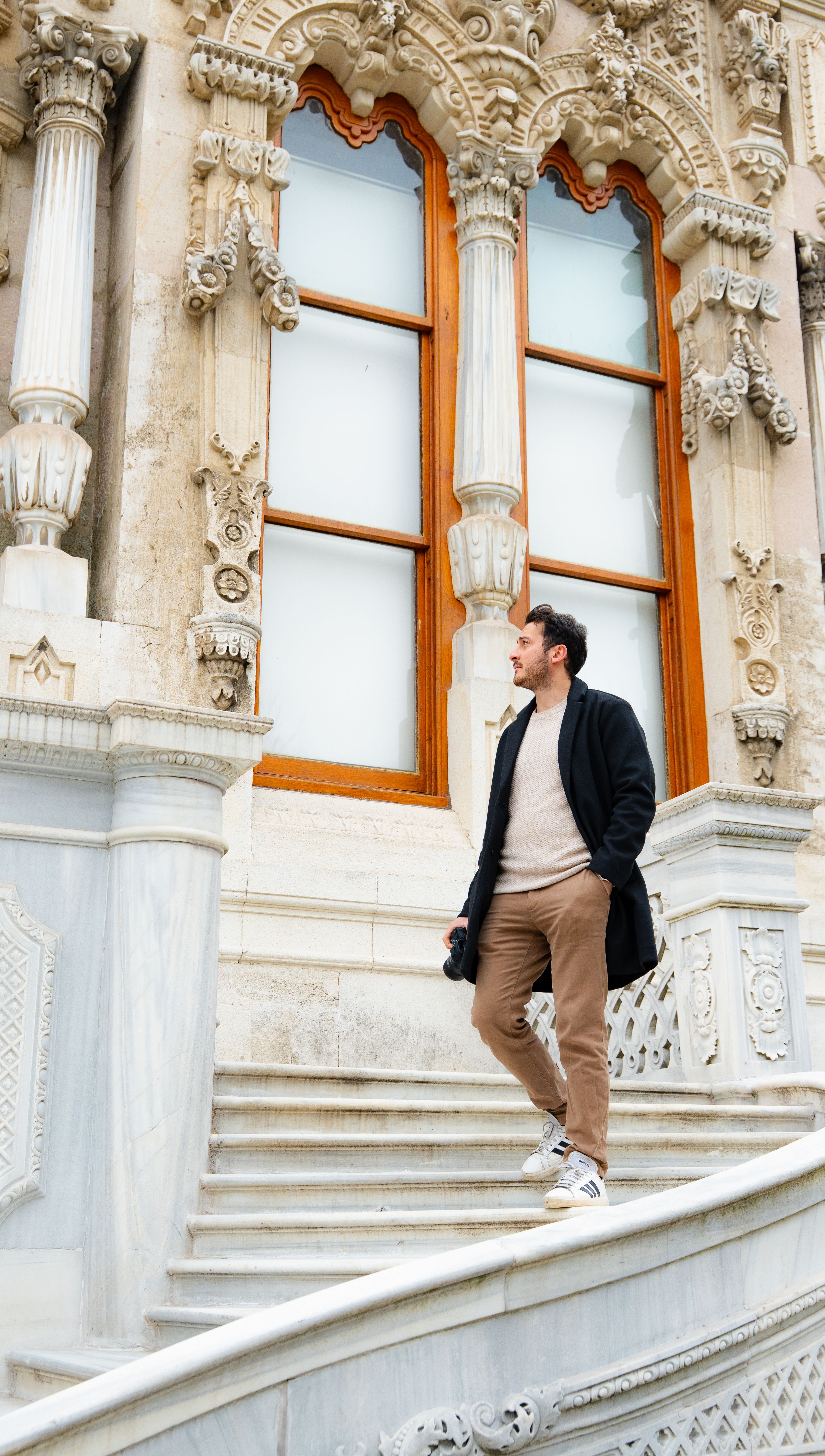 Man Walking by Ornate Historical Building · Free Stock Photo