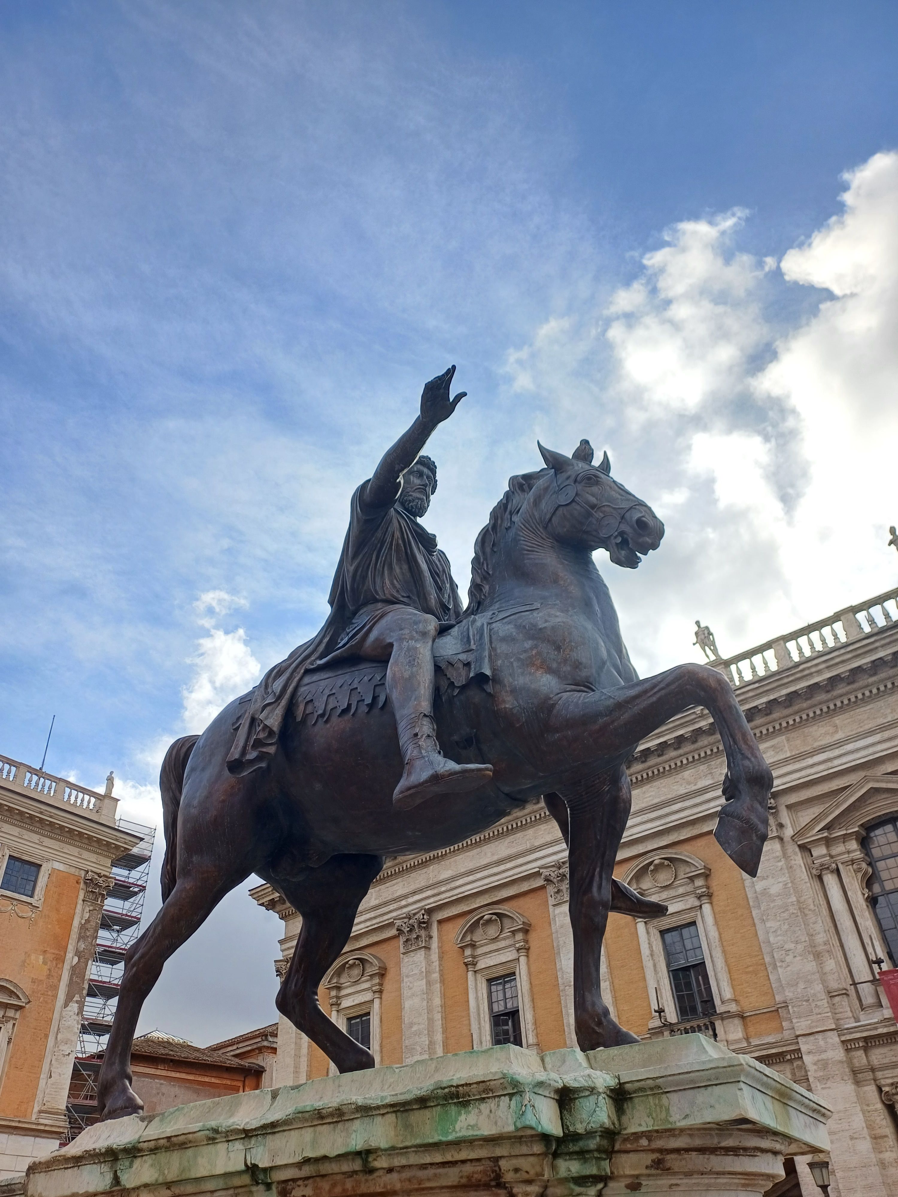 Majestic view of the Equestrian Statue of Marcus Aurelius against a cloudy sky in Rome.