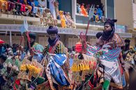 Vibrant cultural horsemen parade in Kano, Nigeria showcasing colorful attire and traditional weapons.