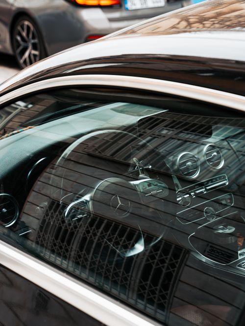 Free Close-up shot of a luxury Mercedes Benz interior with window reflections, emphasizing sleek design. Stock Photo