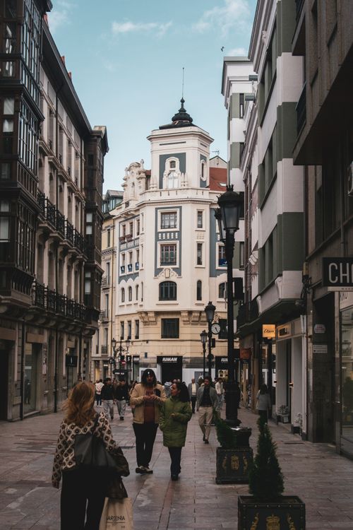 Free Urban street view in Oviedo, Spain featuring elegant buildings and pedestrians on a bustling day. Stock Photo