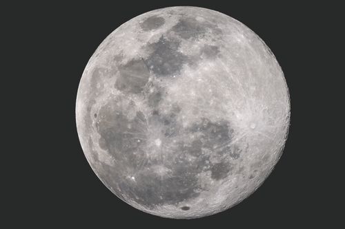 Free High-resolution image of the full moon showcasing visible craters and surface details. Stock Photo