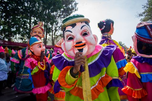Free Colorful parade featuring giant puppets and elaborate masks in vibrant attire, captivating festive atmosphere. Stock Photo