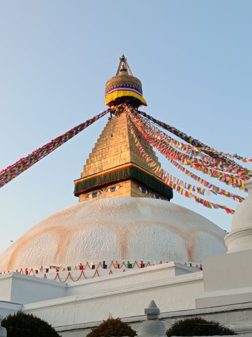 Free Majestic Boudhanath Stupa adorned with colorful prayer flags at sunrise. Stock Photo