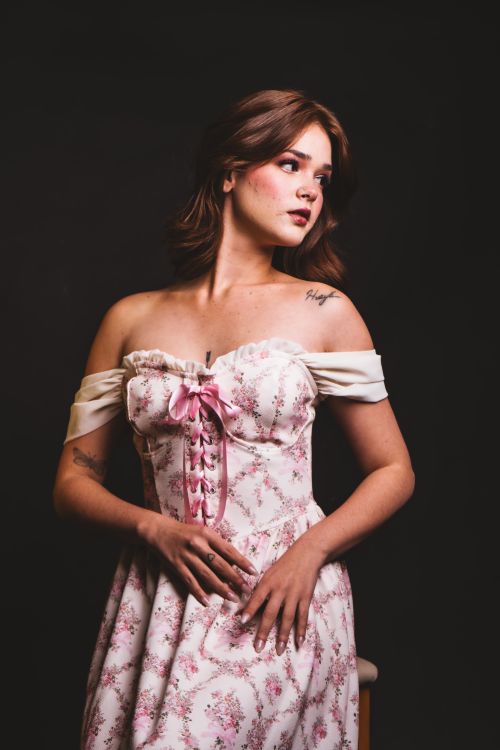 Free Elegant portrait of a woman in a vintage floral dress with a dark background. Stock Photo