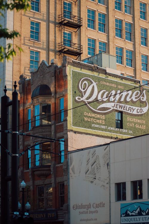 Free Vintage sign for Daynes Jewelry Co. on a historic building in an urban setting. Stock Photo