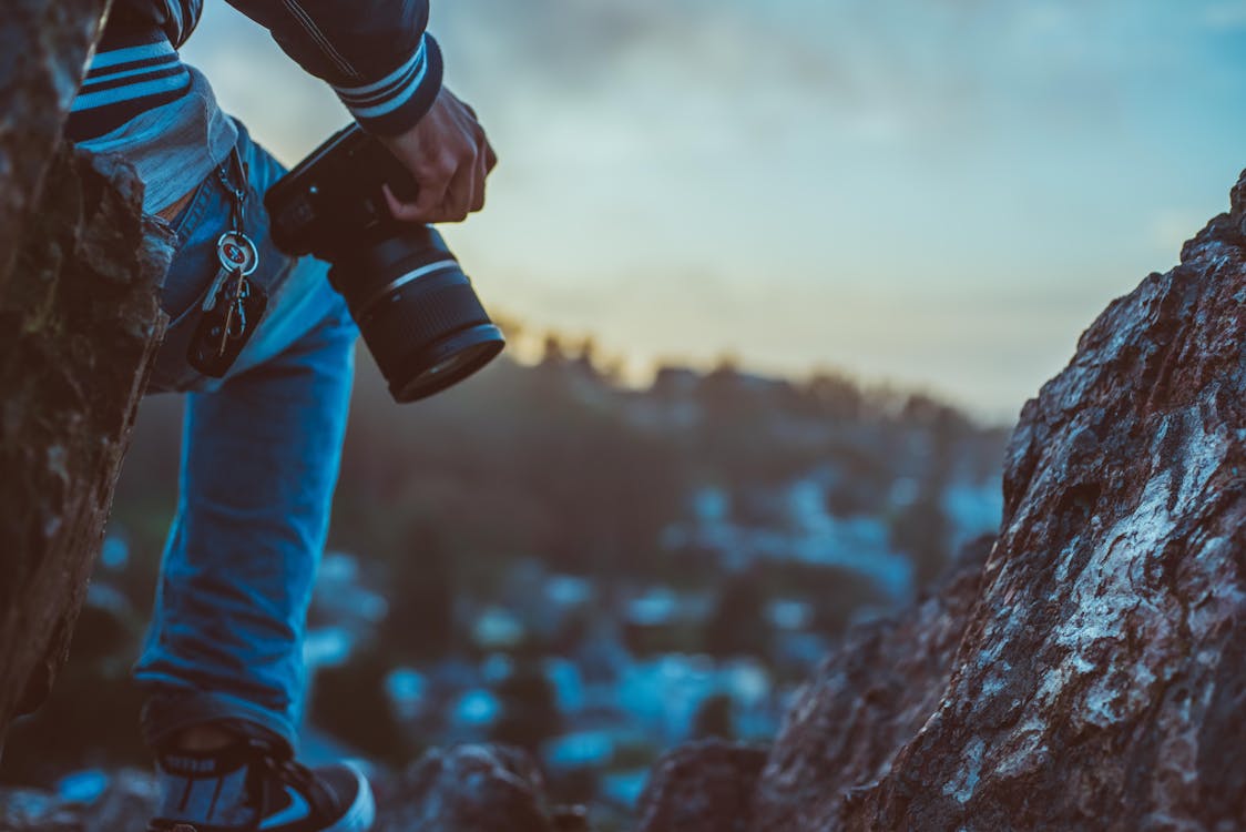 Person Holding Black Dslr Camera