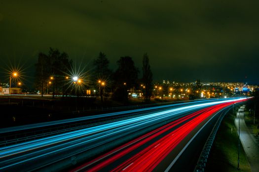 Dynamic light trails on a highway in Jönköping, Sweden, showcasing night traffic and city lights.