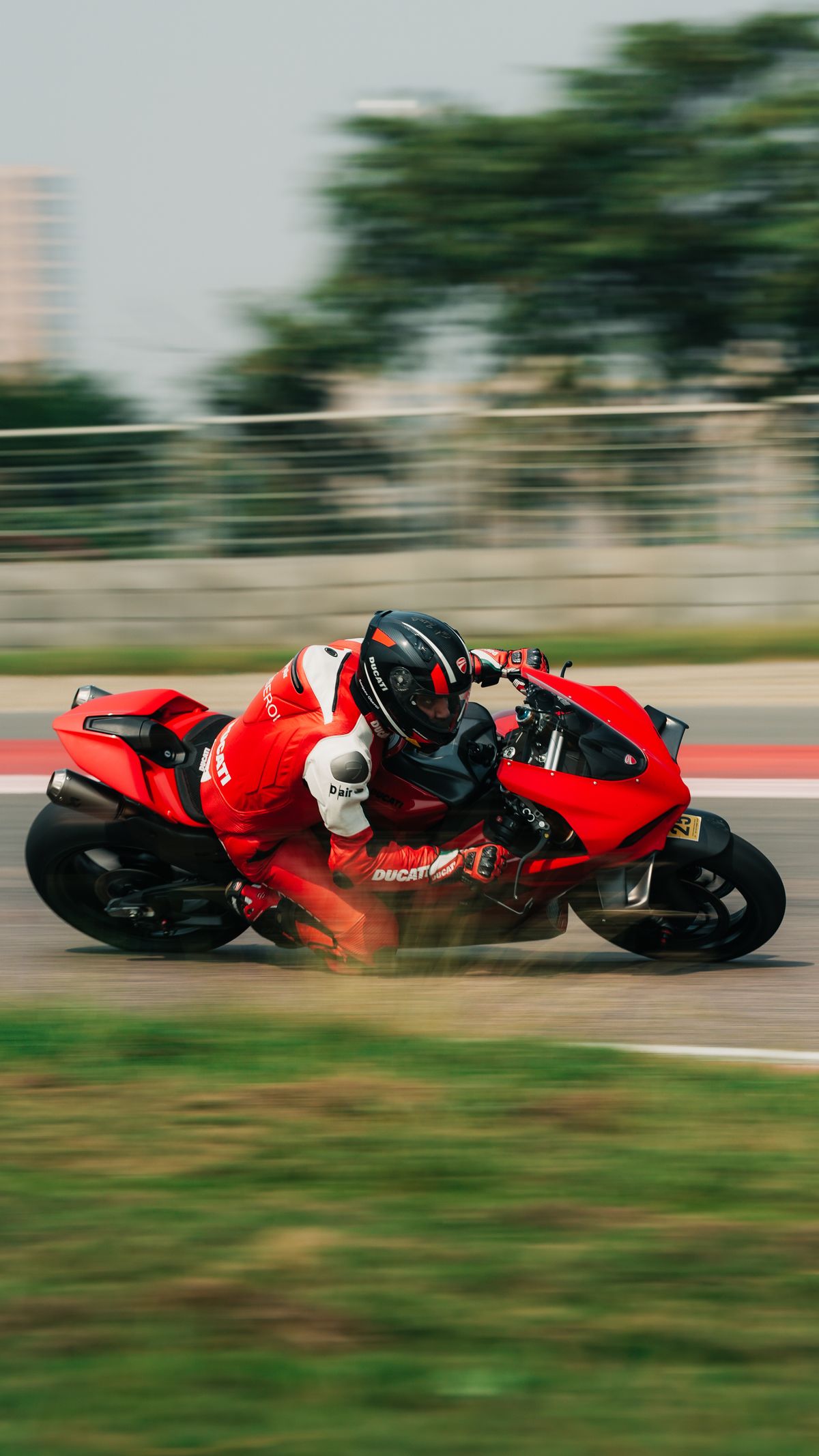 Motorcycle racer leaning into a circuit corner
