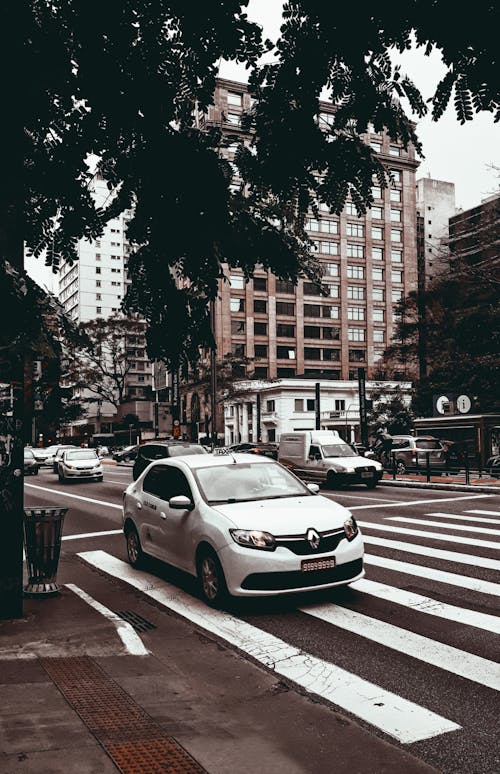 Photo Of White Sedan On Pedestrian Lane