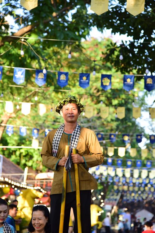 Free Man on stilts at a vibrant outdoor cultural festival, capturing folk traditions. Stock Photo