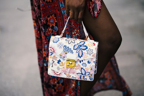 Photo Of Person Holding White Floral Handbag 