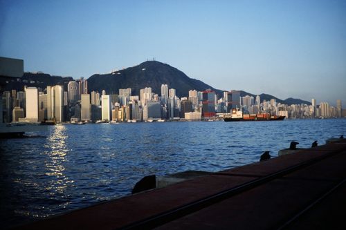 Free A stunning view of Hong Kong Harbor with skyscrapers and mountains during twilight. Stock Photo