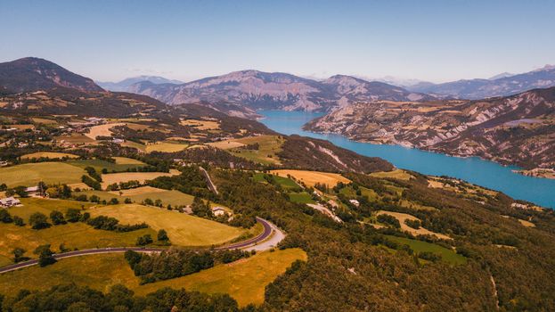 Stunning aerial view of lush landscapes and a serene lake in the French countryside, perfect for travel inspiration.