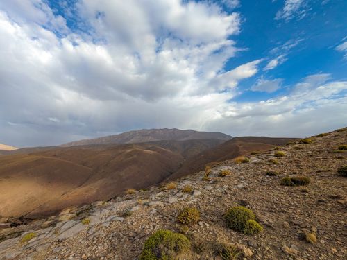 Free Breathtaking view of arid mountains under a dramatic cloudy sky, showcasing natural beauty. Stock Photo