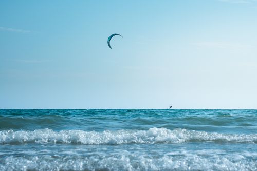 Free Experience thrilling kitesurfing on the serene beaches of Chanthaburi, Thailand. Stock Photo
