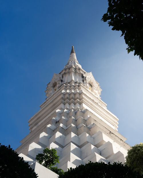 Free A striking view of a Buddhist temple spire against a blue sky in Bangkok, Thailand. Stock Photo