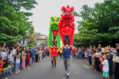 Free Vibrant lion dance at street festival with performers and crowd in attendance. Stock Photo