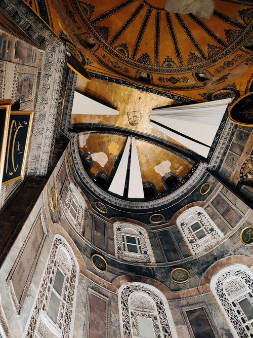 Free A stunning view of intricate architectural details on a historic dome interior using warm colors. Stock Photo