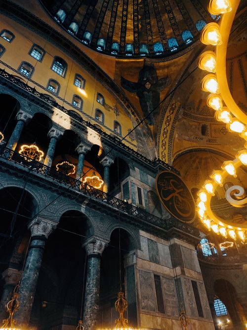 Free View of the breathtaking interior of Hagia Sophia with illuminated chandeliers and detailed architecture. Stock Photo
