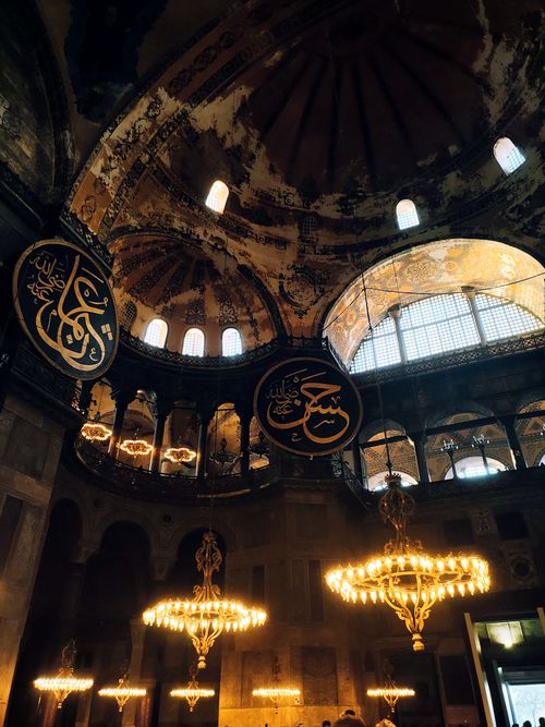Free Captivating view of Hagia Sophia's interior featuring ornate chandeliers and intricate architectural details. Stock Photo